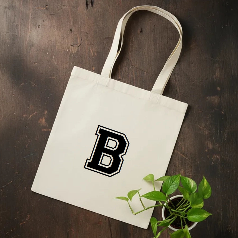 Schwarze Baumwolltasche mit individuellem sportlichen Monogramm-Aufdruck – moderne, personalisierte Stofftasche für Shopping, Freizeit und Training.